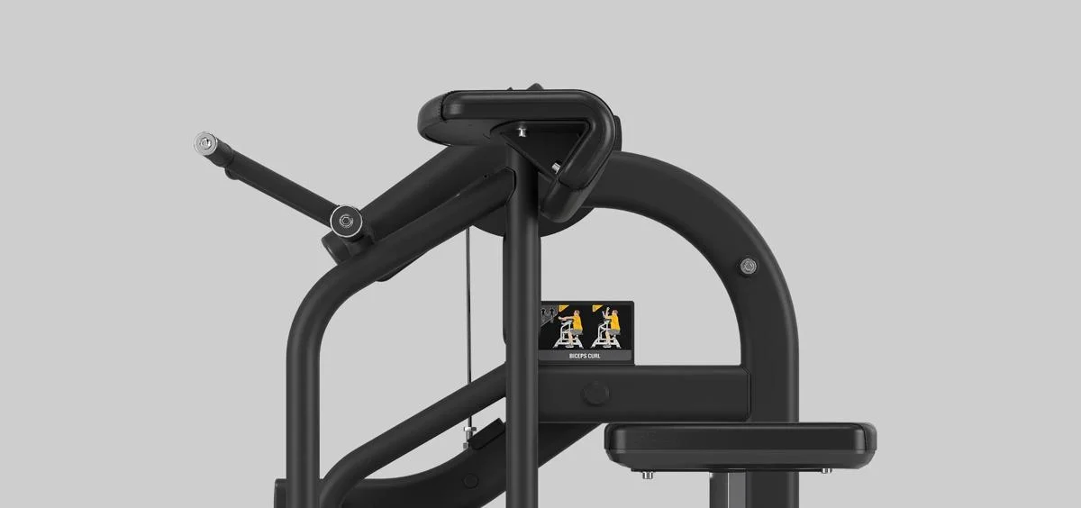 Side view of the Matrix Fitness Biceps Curl machine in Matte Black, featuring padded seat, arm support, and instructional placard.