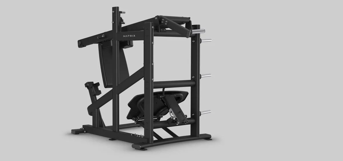 Rear angled view of the full Matrix Fitness leg press machine in Matte Black, showing the seat, frame, footplate, and weight storage pegs.
