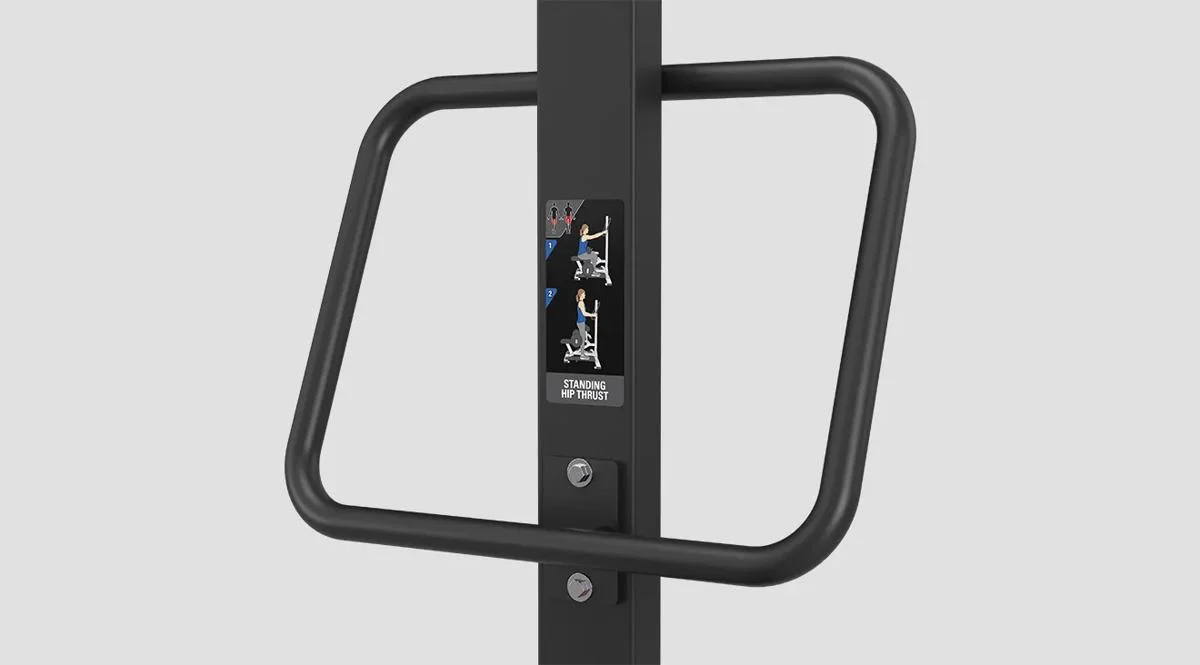 Instructional panel on a Matrix Fitness machine in Matte Black showing illustrations for performing a standing hip thrust, mounted between two vertical stabilizer handles.