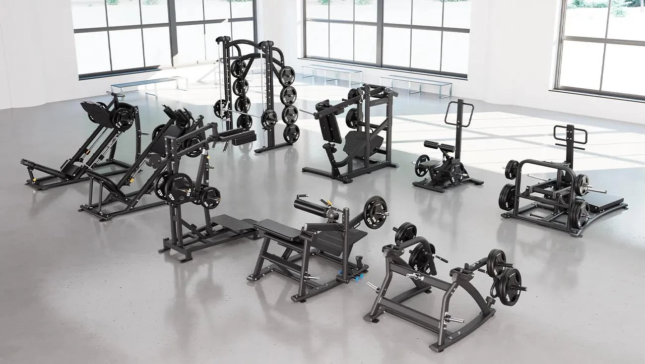Matrix Magnum Glute Package in Matte Black featuring nine strength machines: Belt Squat, Pendulum Squat, Standing Hip Thrust, Smith Machine, Glute Trainer, Squat/Lunge, Hack Squat, 45° Leg Press, and Xult Perfect Squat, displayed in a spacious, light-filled gym with large windows.