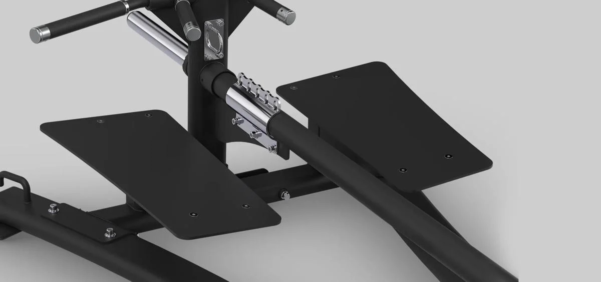 Close-up of the footplate and central bar area of a Matrix Fitness strength training machine in Matte Black, showing angled foot platforms and chrome adjustment components.