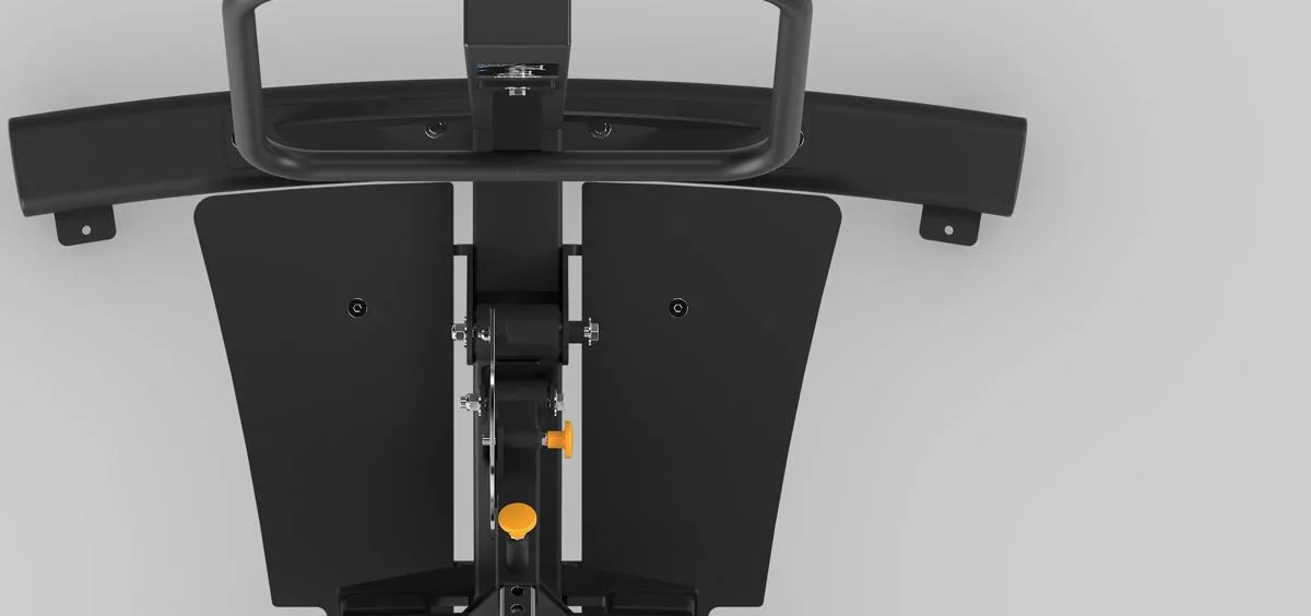 Top-down view of the footplate area on a Matrix Fitness machine in Matte Black, showing two angled platforms and yellow adjustment knobs at the central pivot.