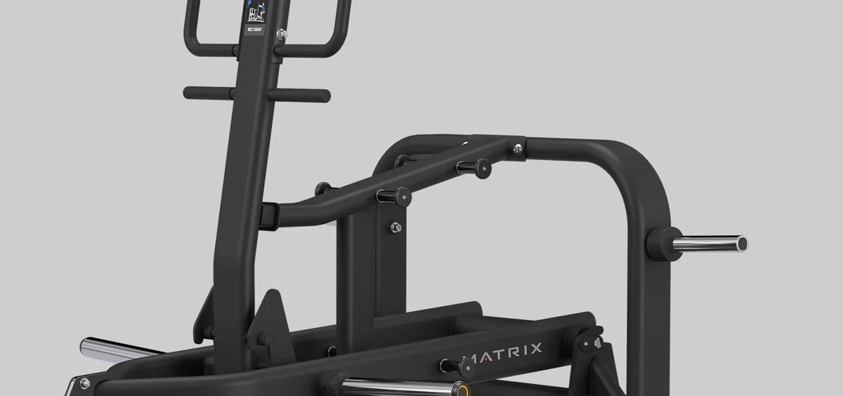 Angled view of the Matrix Fitness Belt Squat machine in Matte Black, showing weight horns, frame, and instructional placard.